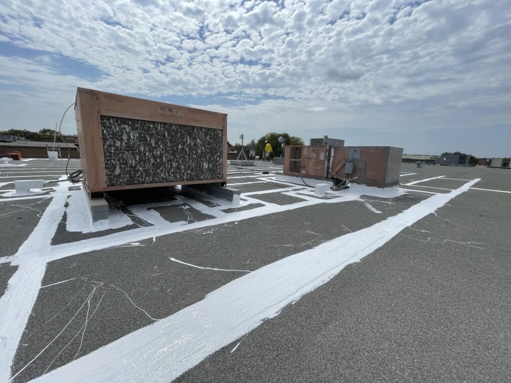 Drip edge and penetration sealing with silicone on the commercial flat roof near E Campbell Rd and N Glenville Dr, Richardson