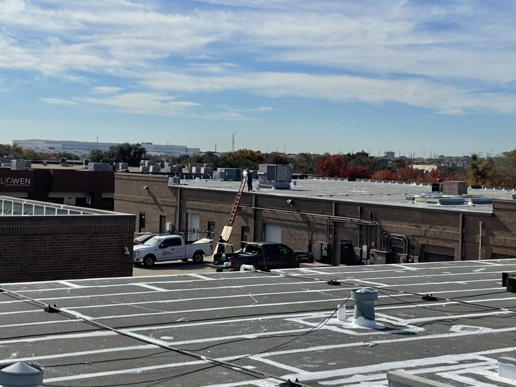 Silicone roof coating over seams and penetrations at the Central Park Business Center complex in Richardson, TX