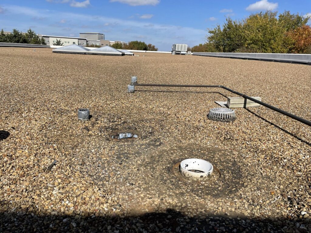 Tar and gravel built-up commercial roof at 2180 N Glenville Dr in the Richardson Telecom Corridor before silicone repair