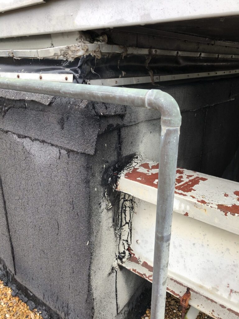 Silicone mastic applied to seams and openings on the degraded RTU curb skirt, N Glenville Dr, Richardson