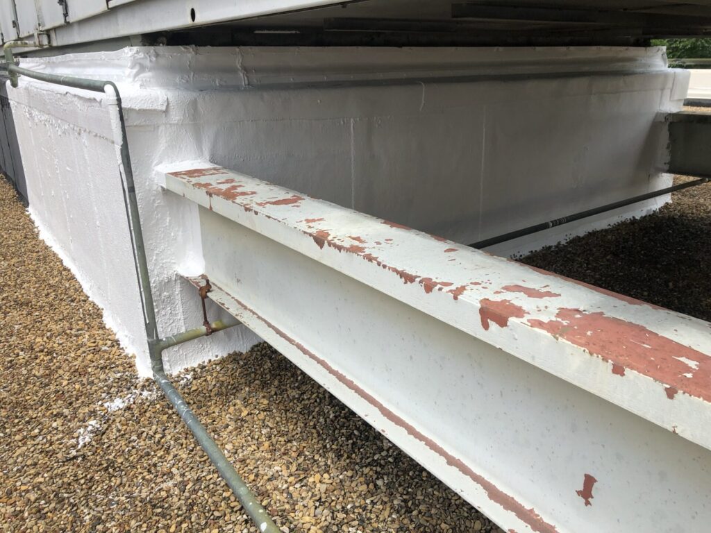 Completed commercial roof leak repair with gravel replaced to conceal the silicone flood coat, Richardson, Texas