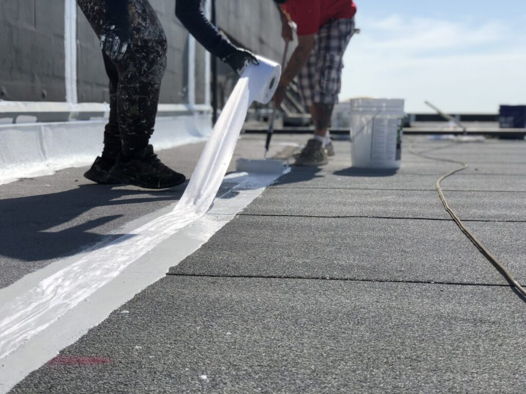 Silicone mastic applied to failing EPDM seams and Mod-Bit sections at LA Fitness, Rowlett, Texas