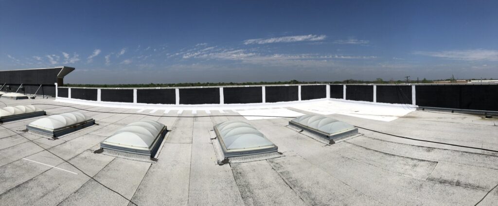 Completed commercial roof repair with sealed coping cap and silicone coating at LA Fitness, Rowlett, Texas