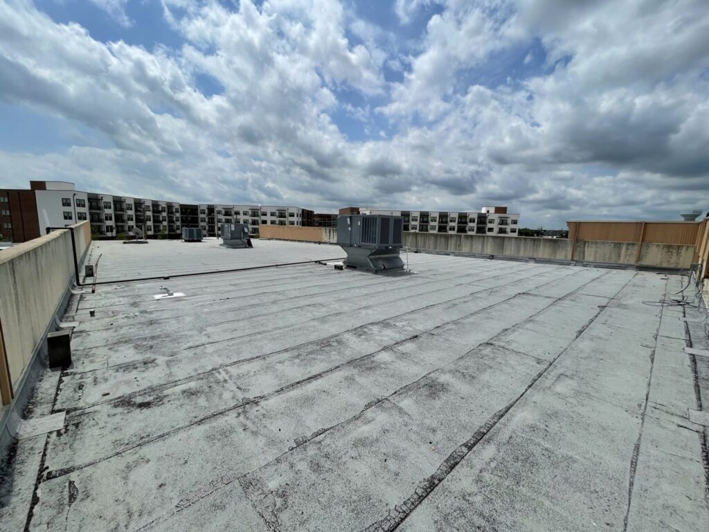 Commercial strip center roof with gas piping and mechanical units before power washing, Rowlett, TX