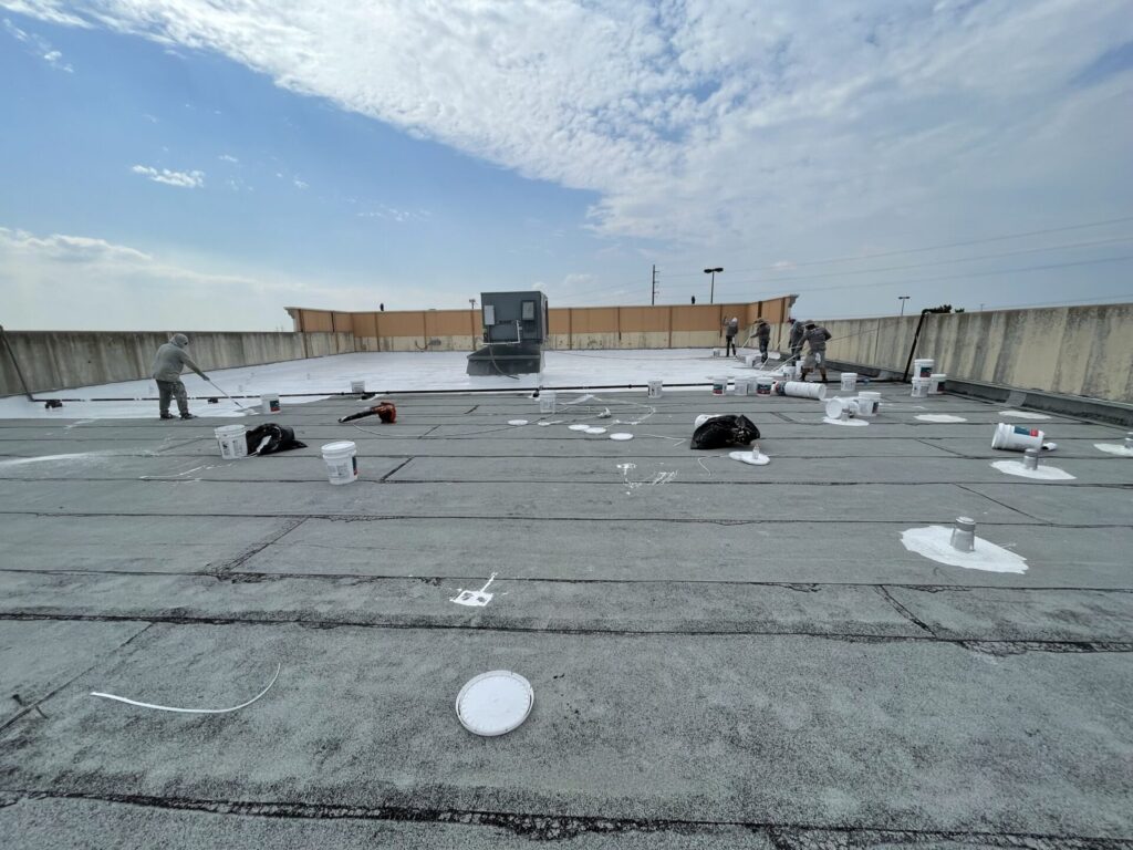 Completed white silicone roof coating at Timberlake Shopping Center — bright, reflective finish, Rowlett, TX