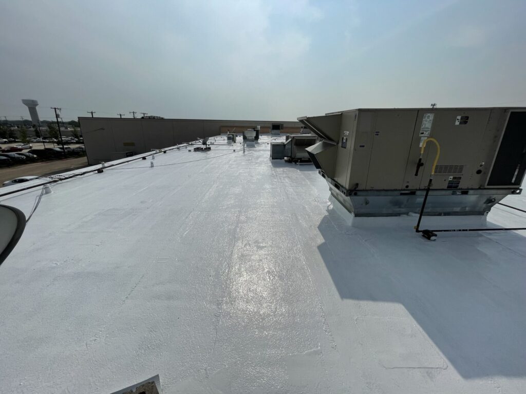 Finished silicone roof coating over the commercial flat roof sections at Timberlake Shopping Center in Rowlett, Texas