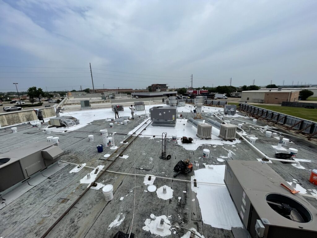 Detail work with silicone mastic at penetrations and termination bars on the 38,000 sq ft strip center roof in Rowlett