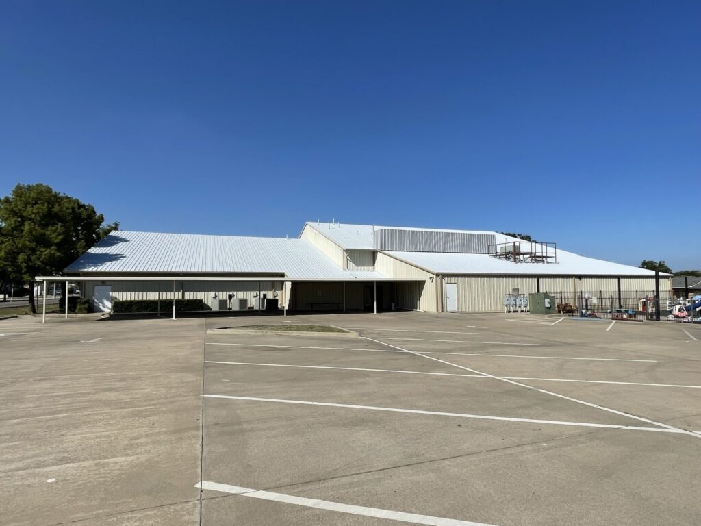Finished dark grey acrylic roof coating on 35,000 sq ft R-panel metal roof, Church of Christ, Sanger, TX