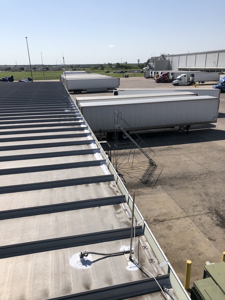 Rusted drip edge fasteners located during industrial roof leak detection at Walmart Distribution Center, Terrell, TX
