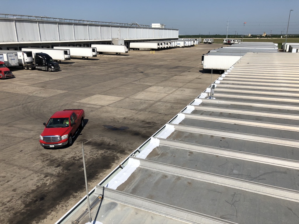 Silicone mastic applied along the 30-foot drip edge section at the Walmart Distribution Center in Terrell, Texas