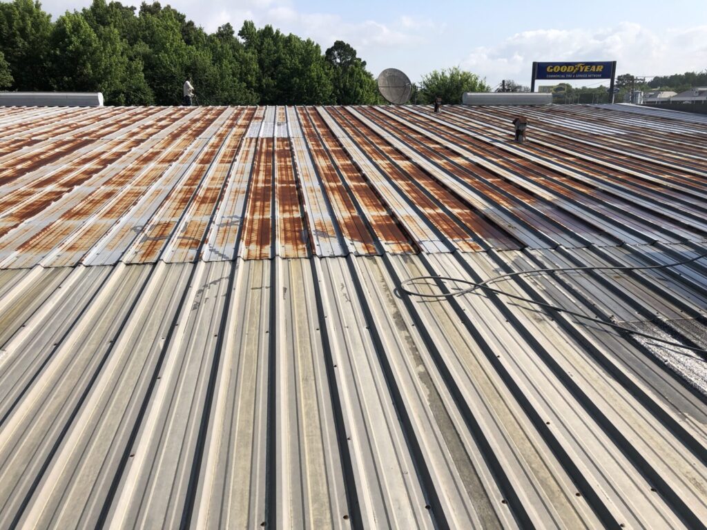 Rusted metal R-panel roof at GoodYear Tire before silicone roof coating, Tyler, TX