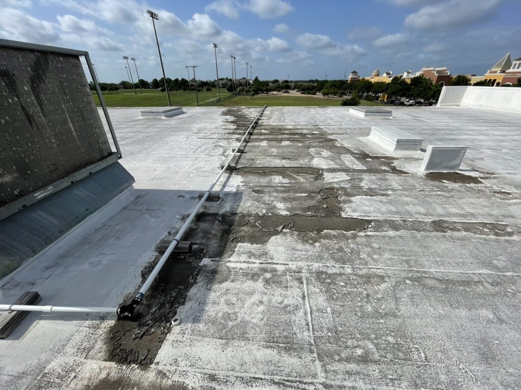 Fabric-reinforced acrylic roof coating delaminating on the 140,000 sq ft roof at 4915 S Cooper St, Arlington, TX