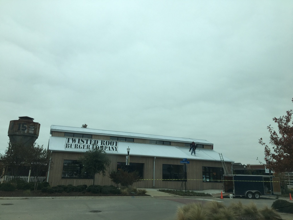 Completed dark grey acrylic roof coating at Twisted Root Burger, 505 Houston St, Coppell, TX