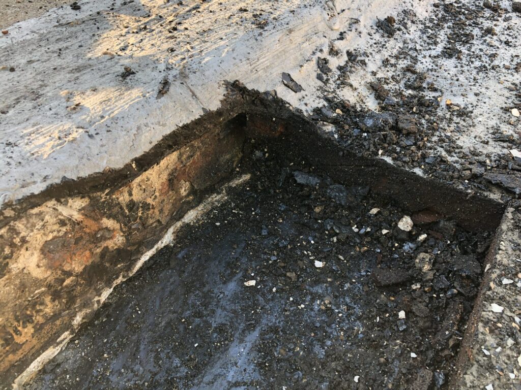 Hole cut into the roof membrane by a concrete contractor on a downtown Dallas high rise, 700 McKinney Ave