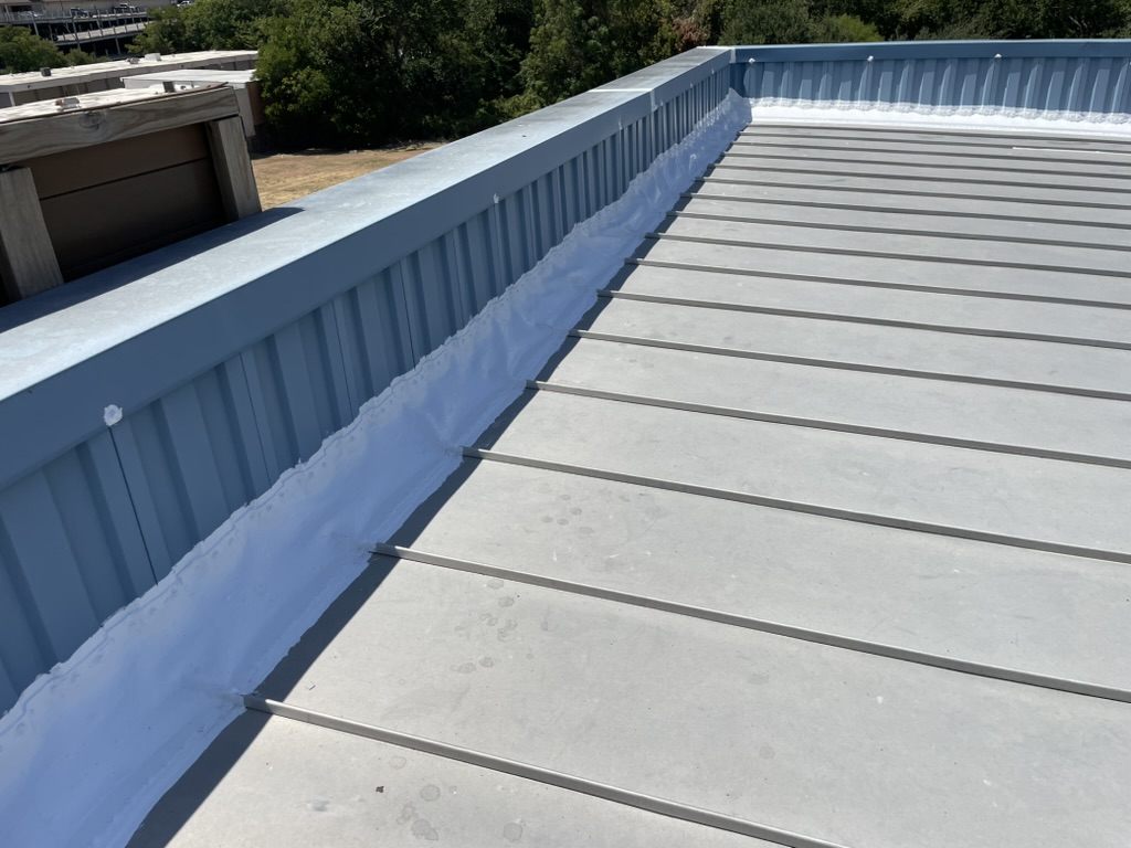 Failed EPDM flashing leaking into the commercial office space at 2419 Inwood Rd, Dallas, TX