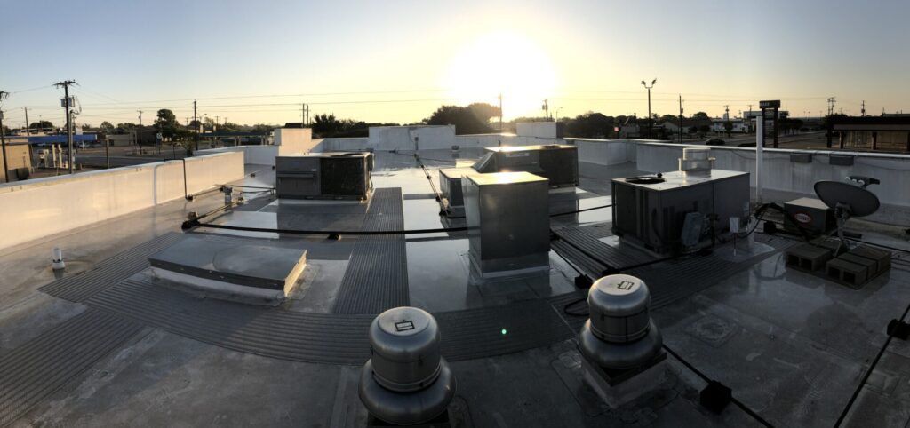 Existing TPO roofing system before restoration at 107 S Cedar Ridge Dr, Duncanville, TX
