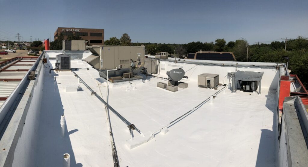 Silicone roof coating going down over the existing Mod-Bit roofing system on Altamesa Blvd, Fort Worth