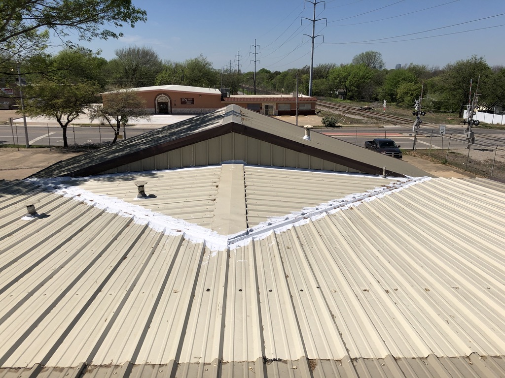 Metal R-panel roof valley leaking at 1001 Miller Ave in Southeast Fort Worth, TX