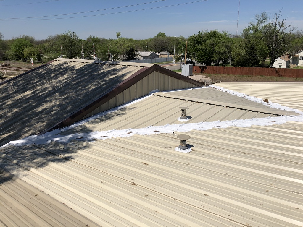 Nylon mesh embedded in silicone during the 3-course fabric reinforcement of the roof valley, Fort Worth