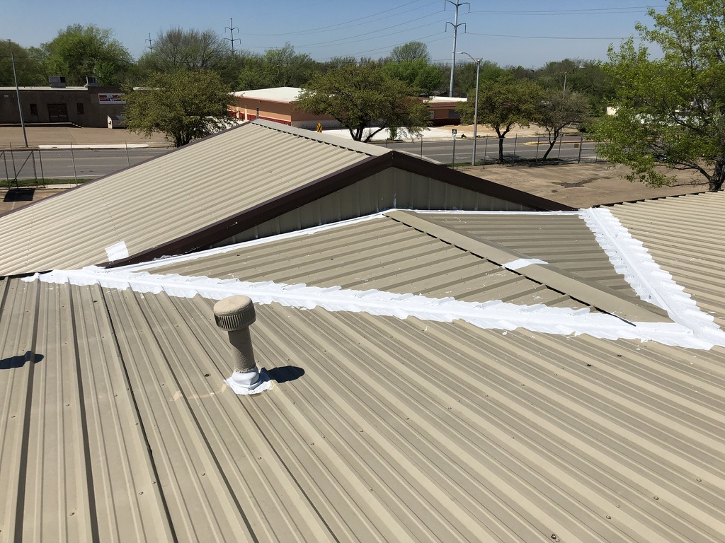 Completed 3-course silicone valley repair on the R-panel roof at E Rosedale St and Miller Ave, Fort Worth, TX