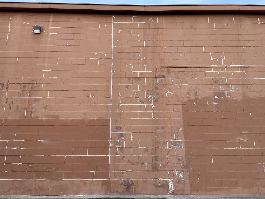Failed commercial gutter seams letting water run down the block wall every 10 feet, Grapevine