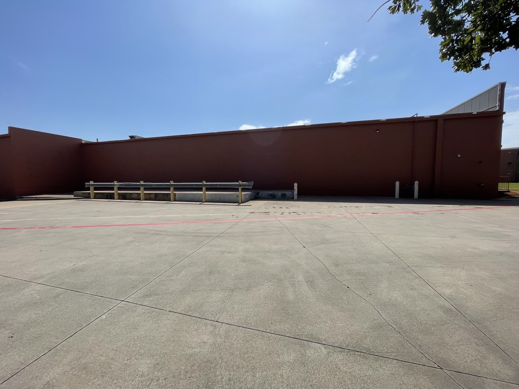 Completed custom colored acrylic masonry wall coating over the restored rear wall, Grapevine, TX