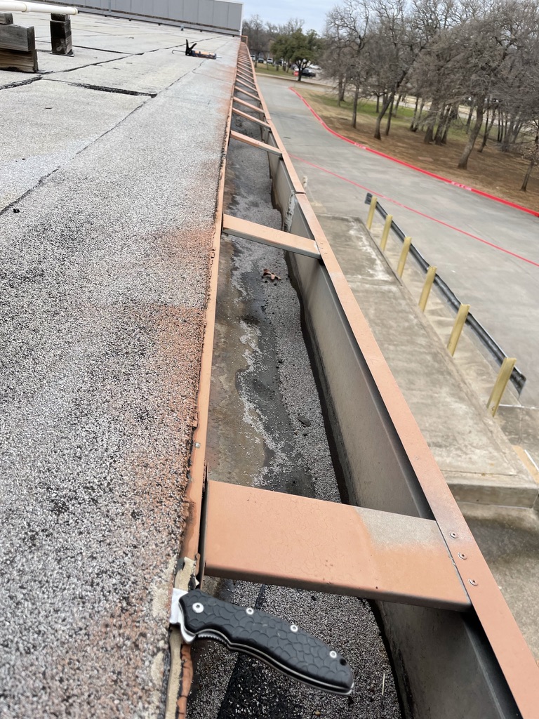 Failing pitch pan identified during leak mapping on the Grapevine strip center roof