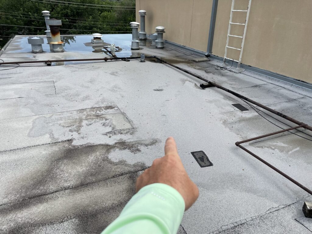 Modified Bitumen commercial roof on a strip center in Irving, Texas being inspected for storm damage