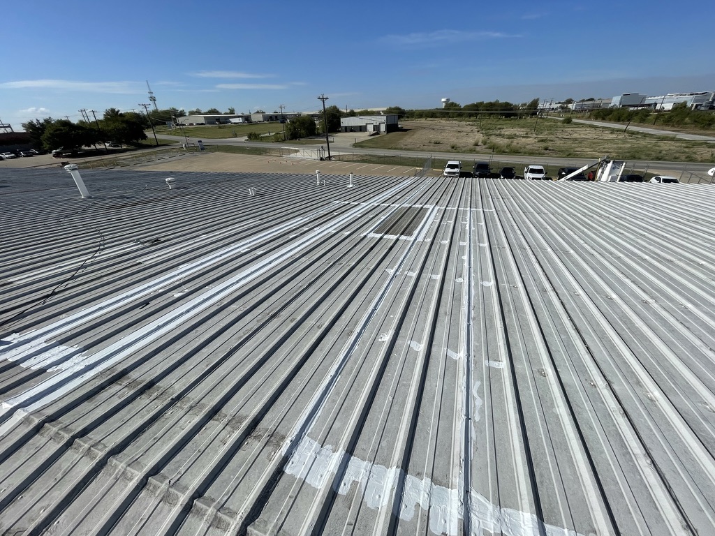Acrylic mastic applied to bond the failed seams back together on the metal roof, Mansfield, Texas