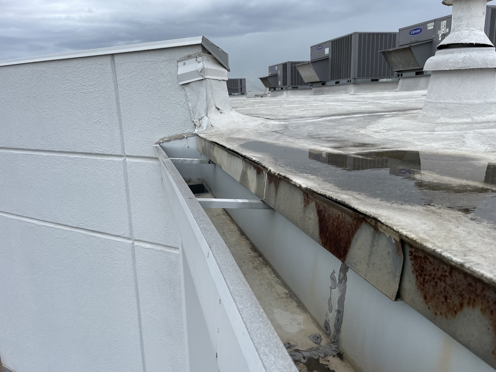 Separation between the perimeter metal drip edge and the roof membrane — the root of the coating failure, Saginaw, TX