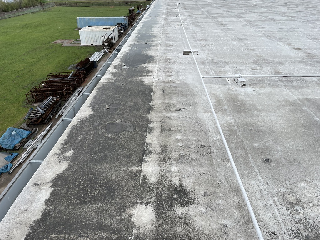 Delaminated silicone coating on the 90,000 sq ft commercial roof in Saginaw, Texas
