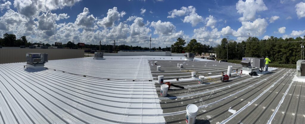 Panoramic view of the roof mid-application showing the coated and uncoated sections side by side, Conroe, TX