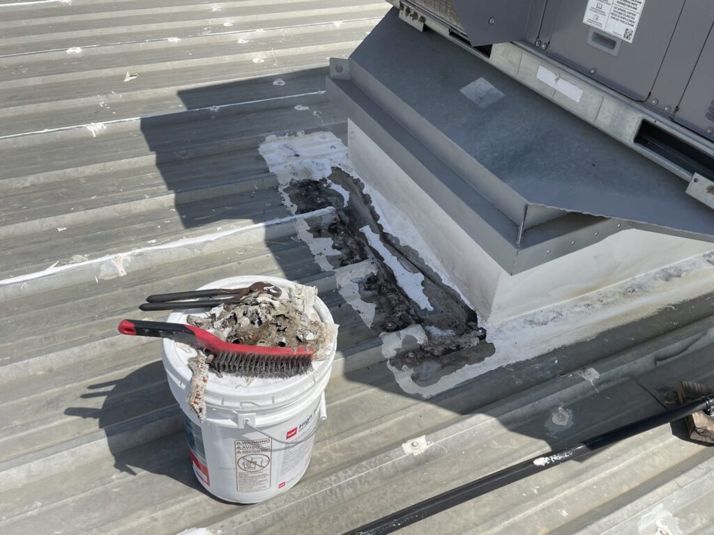 Silicone mastic detailing at an HVAC curb penetration on the metal roof, Conroe, TX