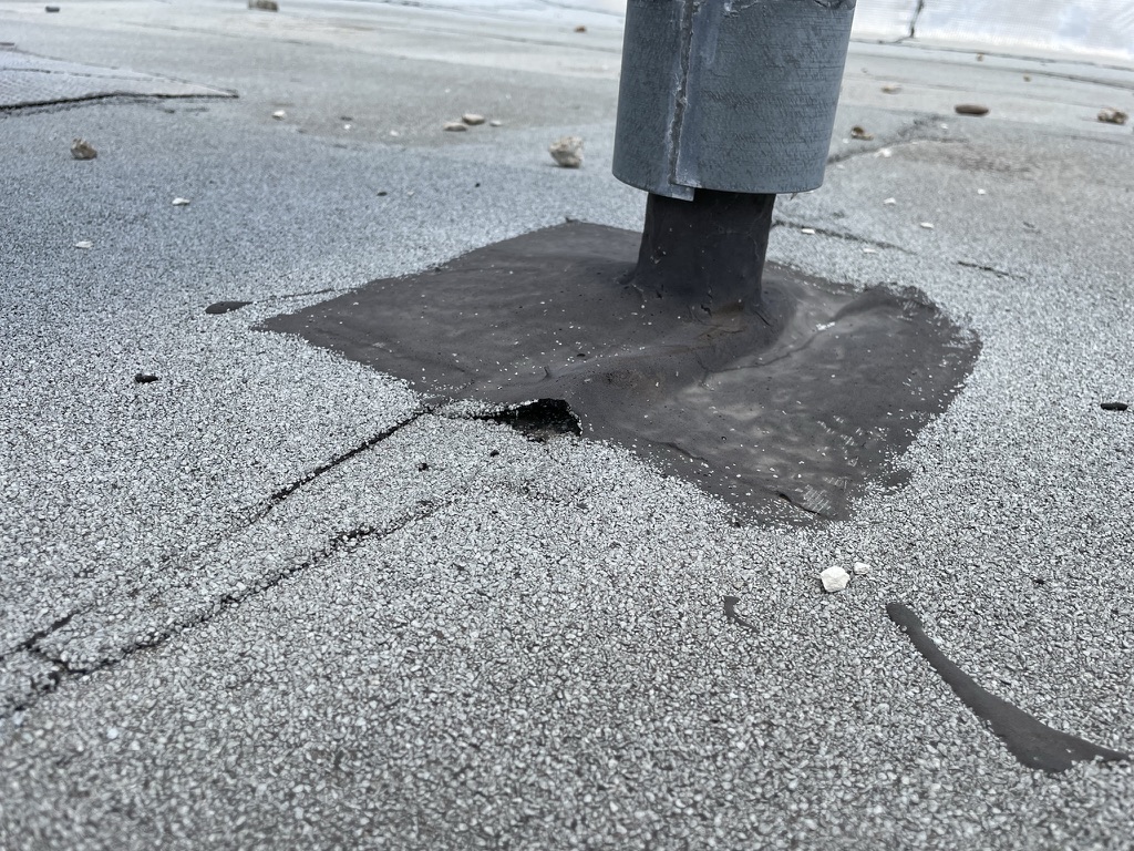 Debris and membrane wear near the roof drain at the AT&T property on Military Pkwy, Dallas
