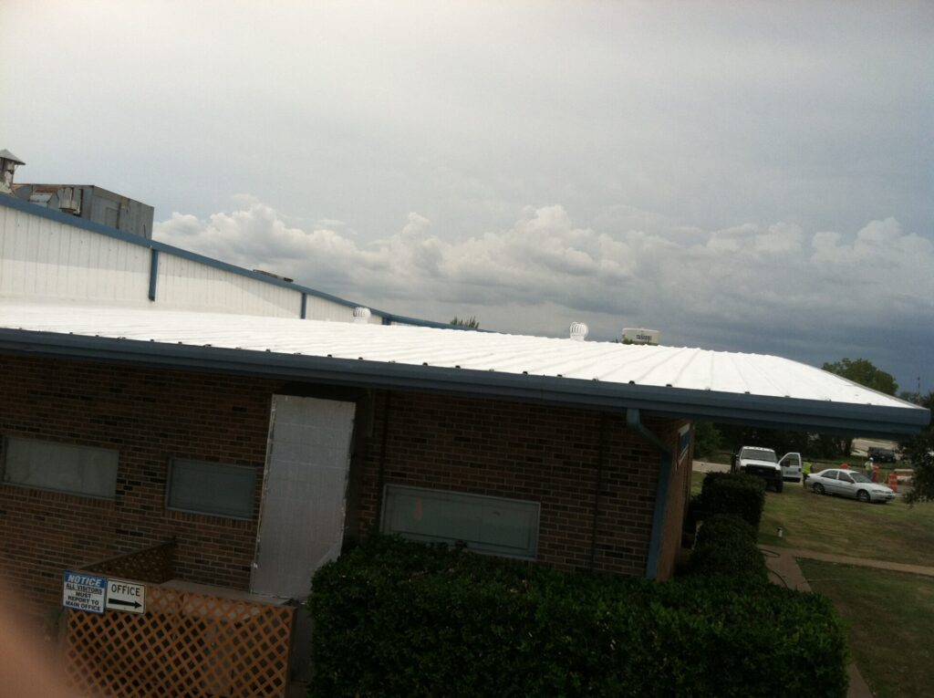 Completed acrylic roof coating over the front section of the Quadrant Performance Materials facility, 200 Industrial Blvd, McKinney, TX