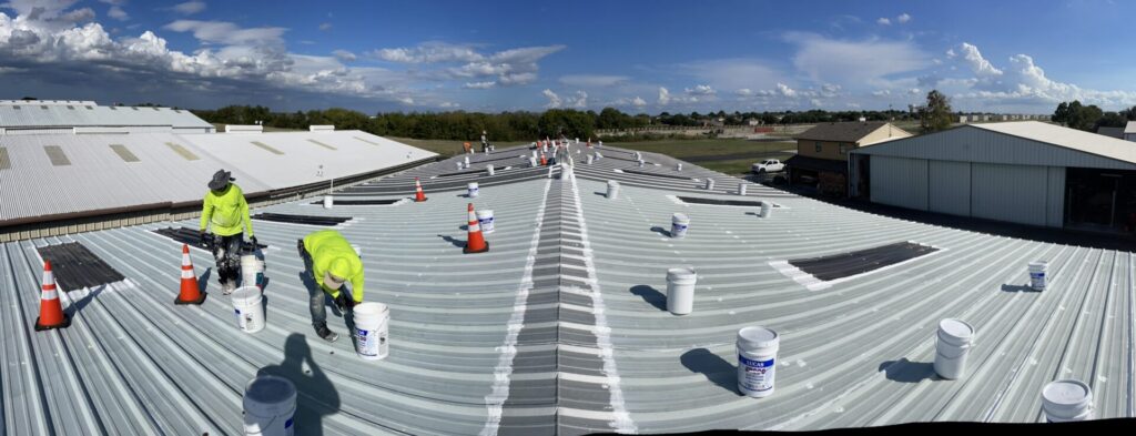 McKinney R-panel roof with seam and fastener repairs before the full white coating